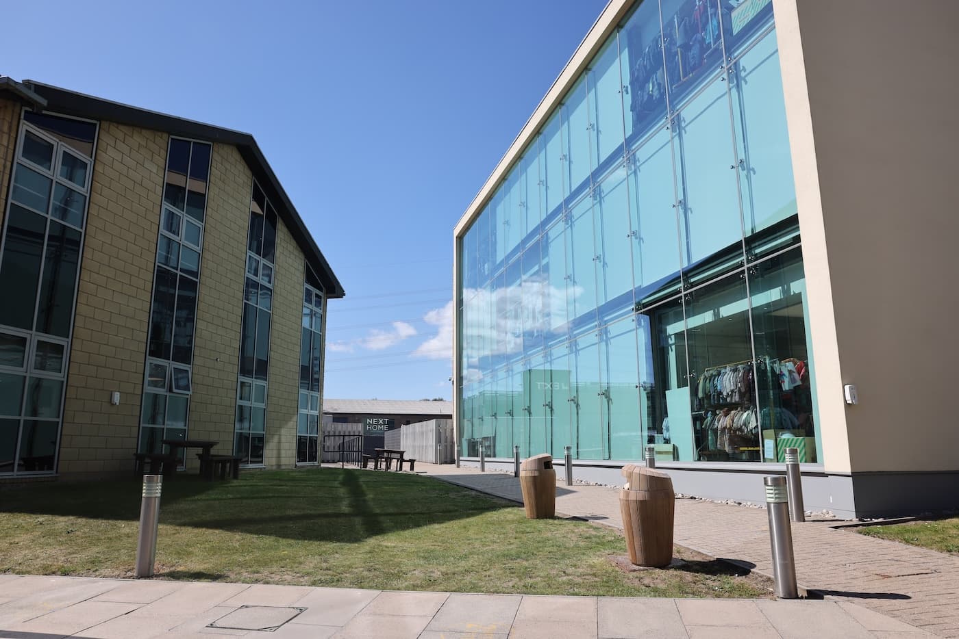 The NEXT Leicester campus building, featuring an all glass office, in the sunshine 