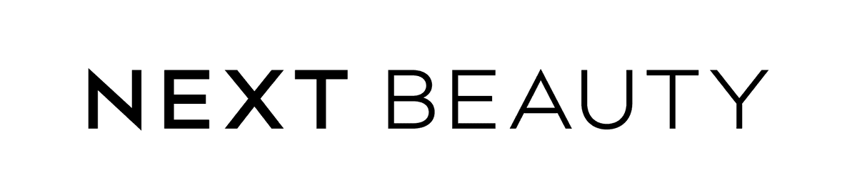 Black "NEXT BEAUTY" logo in uppercase serif font, with the words stacked vertically and evenly spaced.